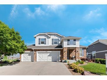 Inviting two-story home showcasing a three-car garage and charming stone and siding exterior at 4515 W 107Th Cir, Westminster, CO 80031