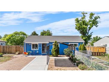 Charming blue single-story home with a well-maintained front yard and unique covered parking at 935 S Pecos Way, Denver, CO 80223