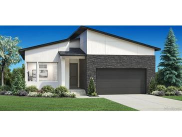 Modern home featuring stone accents, a two-car garage, and professionally landscaped lawn at 6353 Verve Ln, Parker, CO 80134