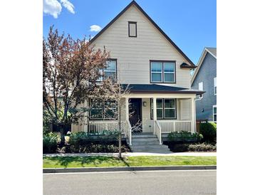 Charming two-story home with a cozy front porch and well-maintained landscaping at 10822 E 28Th Pl, Denver, CO 80238