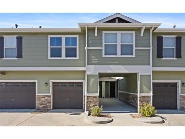 Green two-story townhome with attached garage and landscaping at 17101 Waterhouse Cir # B, Parker, CO 80134