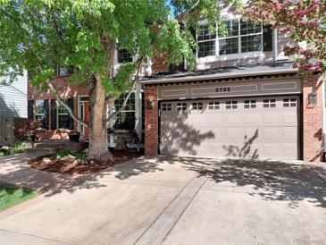 Charming two-story home with a brick facade, attached garage, and mature trees at 2732 Flint Ct, Superior, CO 80027
