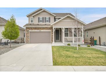 Charming two-story home features a welcoming front porch and a well-maintained lawn at 4552 S Perth Ct, Aurora, CO 80015