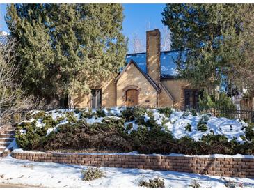 Brick home with snow-covered landscaping and a charming front entrance at 636 York St, Denver, CO 80206