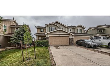 Two-story home with a two-car garage, landscaped front yard, and neutral-colored exterior with a paved driveway at 5653 Raleigh Cir, Castle Rock, CO 80104