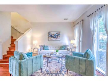 Bright living room with stylish blue accent chairs, a neutral sofa, and elegant decor at 232 W 5Th Ave, Denver, CO 80204
