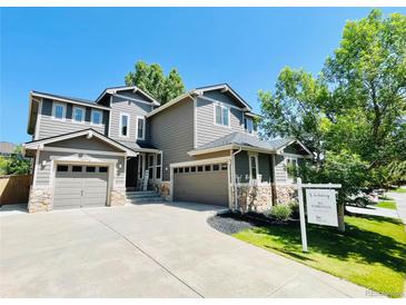 Charming two-story home with a three-car garage and meticulously landscaped front yard at 10774 Chadsworth Ln, Highlands Ranch, CO 80126