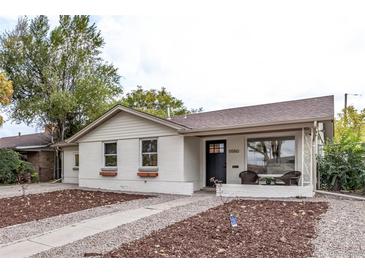 Charming ranch home with freshly painted exterior and landscaped front yard at 5550 E Thrill Pl, Denver, CO 80207