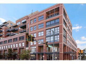 Attractive brick building with balconies and multiple windows on a sunny day, located on the corner of 15th Street and Palace Lofts at 1499 Blake St # 3U, Denver, CO 80202