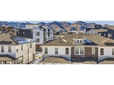 Aerial view of townhouses with mountain backdrop; showcasing community and landscape at 9656 Browns Peak Cir, Littleton, CO 80125