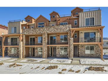 Three-story townhouses with stone accents and private balconies at 9656 Browns Peak Cir, Littleton, CO 80125