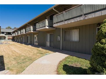 Charming condominium with balconies, green siding and well maintained common outdoor area at 9925 W 20Th Ave # 2, Lakewood, CO 80215