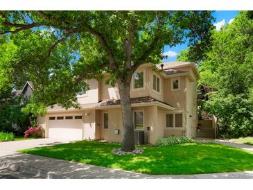 Charming two-story home featuring a well-maintained lawn, mature trees, and a spacious two-car garage, perfect for families at 5530 Racquet Ln, Boulder, CO 80303