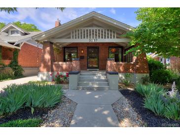 Charming brick home with a cozy front porch and manicured landscaping at 3237 N Josephine St, Denver, CO 80205