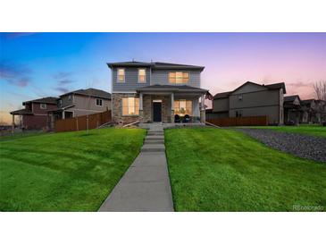 Beautiful two-story home with a well-maintained lawn and inviting front porch at 11677 Park South Ln, Parker, CO 80138