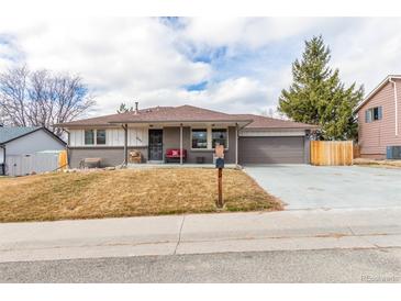 Charming single-story home featuring a well-maintained front yard and attached two-car garage at 6343 Depew St, Arvada, CO 80003