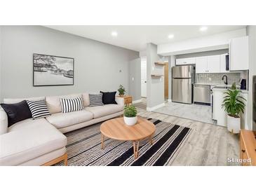 Open living room featuring L-shaped sofa and modern coffee table at 2707 Valmont Rd # 106B, Boulder, CO 80304