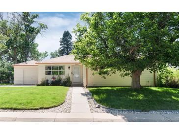 Charming single-story home with a well-maintained lawn and mature shade tree in a desirable neighborhood at 5215 S Washington St, Littleton, CO 80121