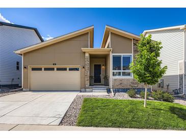 Charming home featuring a two-car garage, landscaped front yard, and stylish architectural details at 268 Simmental Loop, Castle Rock, CO 80104