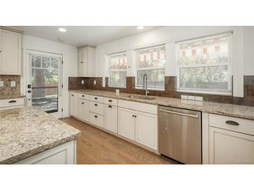Bright kitchen with stainless steel appliances, granite countertops, and wooden cabinets at 5000 S Chester St, Greenwood Village, CO 80111