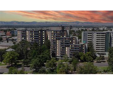 Beautiful condominium building with lush landscaping and mountain views at sunset at 601 W 11Th Ave # 1109, Denver, CO 80204