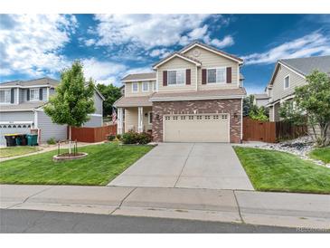 Charming two-story home with a brick facade, manicured lawn, and inviting curb appeal at 10245 Nottingham Dr, Parker, CO 80134