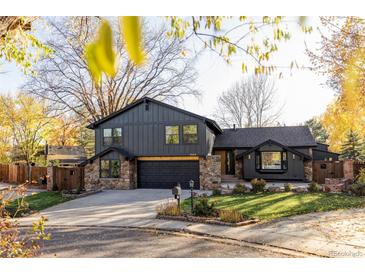 Beautiful two-story home with stone accents, a well-manicured lawn, and mature trees at 4269 Carter Trl, Boulder, CO 80301