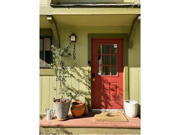 Charming front entrance with a red door, planters, and clearly marked house number at 3209 Redstone Rd # 12B, Boulder, CO 80305