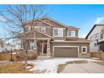 Inviting two-story home with a well-manicured front yard and attached two-car garage at 5531 Fox Meadow Ave, Highlands Ranch, CO 80130