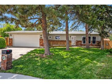 Charming ranch home with mature trees, a well-maintained lawn, and a two-car garage at 7773 Brentwood Ct, Arvada, CO 80005
