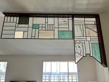 Unique stained glass partition adds character and charm above a bright window at 775 S Alton Way # 3D, Denver, CO 80247