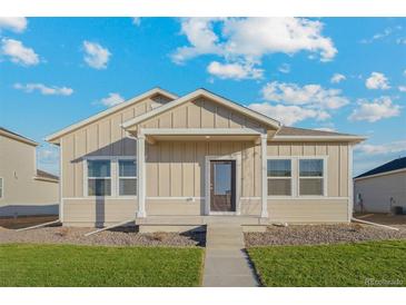 Charming single-story home featuring a covered porch, neutral siding, and a well-manicured lawn at 2986 Oxley St, Strasburg, CO 80136