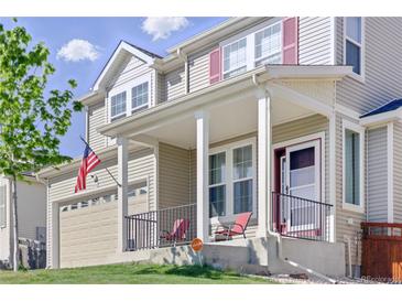 Inviting two-story home featuring a covered front porch and a well-maintained lawn at 1673 Morningview Ln, Castle Rock, CO 80109