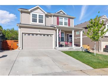 Charming two-story home with a well-manicured lawn and an attached two-car garage at 1673 Morningview Ln, Castle Rock, CO 80109