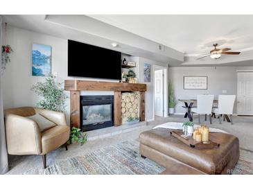 Inviting living room featuring a cozy fireplace, comfortable seating, and stylish decor at 920 E Plum Creek Pkwy # 306, Castle Rock, CO 80104