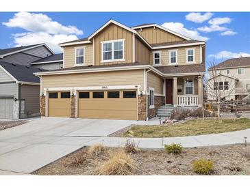 Inviting two-story home showcasing a two-car garage, stone accents, and a well-maintained front yard at 10913 Ledges Rd, Parker, CO 80134
