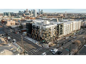 Modern apartment building with unique facade, city skyline, and street view at 2880 Zuni St # 308, Denver, CO 80211