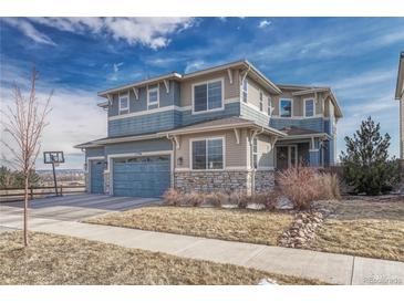 Charming two-story home with a well-manicured lawn, a two car garage, and beautiful stone accents at 11796 Edenfeld St, Parker, CO 80134