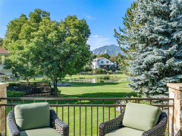 Deck overlooks pond, mountains, and lush green space at 2512 Premier Pl, Boulder, CO 80304