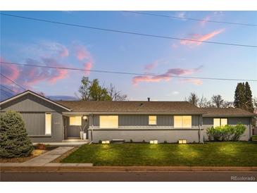 Charming single-story home featuring a well-maintained lawn and a freshly painted gray exterior at 7155 E Exposition Ave, Denver, CO 80224