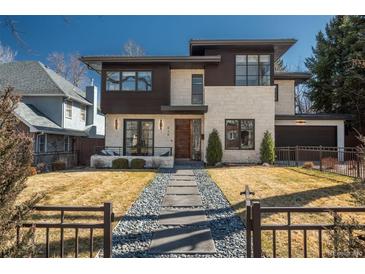 Modern two-story home showcasing a manicured lawn and stone walkway leading to the front entrance at 424 Grape St, Denver, CO 80220