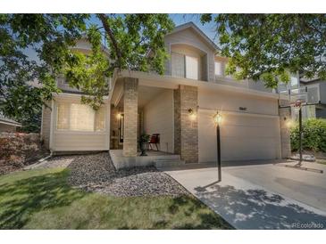 Charming two-story home featuring a well-manicured lawn and a welcoming front porch at 18647 E Berry Dr, Aurora, CO 80015