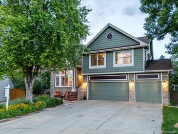 Inviting two-story home with a manicured lawn, a three-car garage, and a charming brick and wood facade at 601 E 131St Ct, Thornton, CO 80241