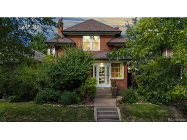 Brick home with classic architecture, mature landscaping, and inviting front porch at 425 N Pennsylvania St, Denver, CO 80203