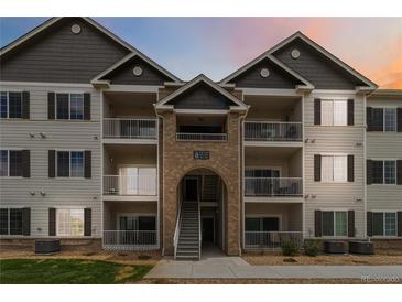 Charming condo complex with balconies, brick accents, and well-maintained landscaping at 15700 E Jamison Dr # 305, Englewood, CO 80112