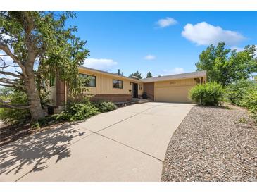 Inviting ranch-style home with a brick and siding exterior, featuring a spacious driveway and a well-maintained front yard at 2711 S Fenton St, Denver, CO 80227