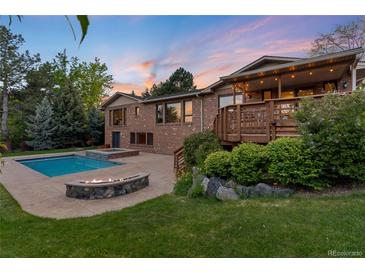 Inviting backyard features a sparkling pool, fire pit, deck, and lush landscaping at 92 S Devinney St, Golden, CO 80401