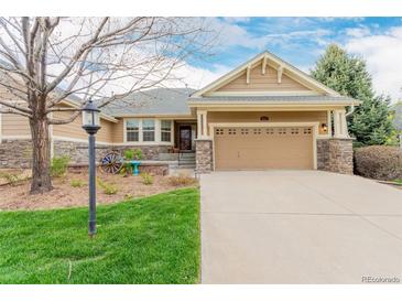Charming home with a manicured lawn and neutral exterior with an attached two car garage at 8525 E 149Th Dr, Thornton, CO 80602