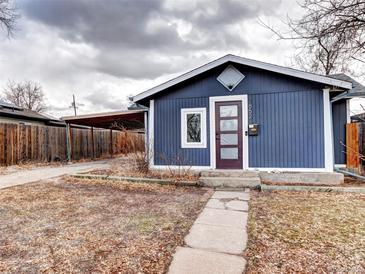 Charming blue home featuring a covered parking area and a well-maintained front yard at 2852 W Ellsworth Ave, Denver, CO 80219