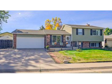 Ranch style home with attached garage and landscaped yard at 2519 S Sable Way, Aurora, CO 80014